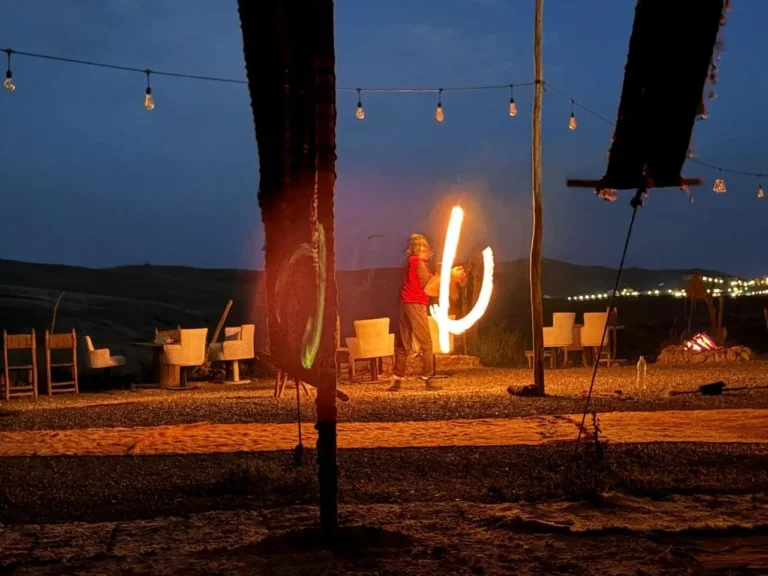 Fire performer lighting up a desert camp in Agafay after dark