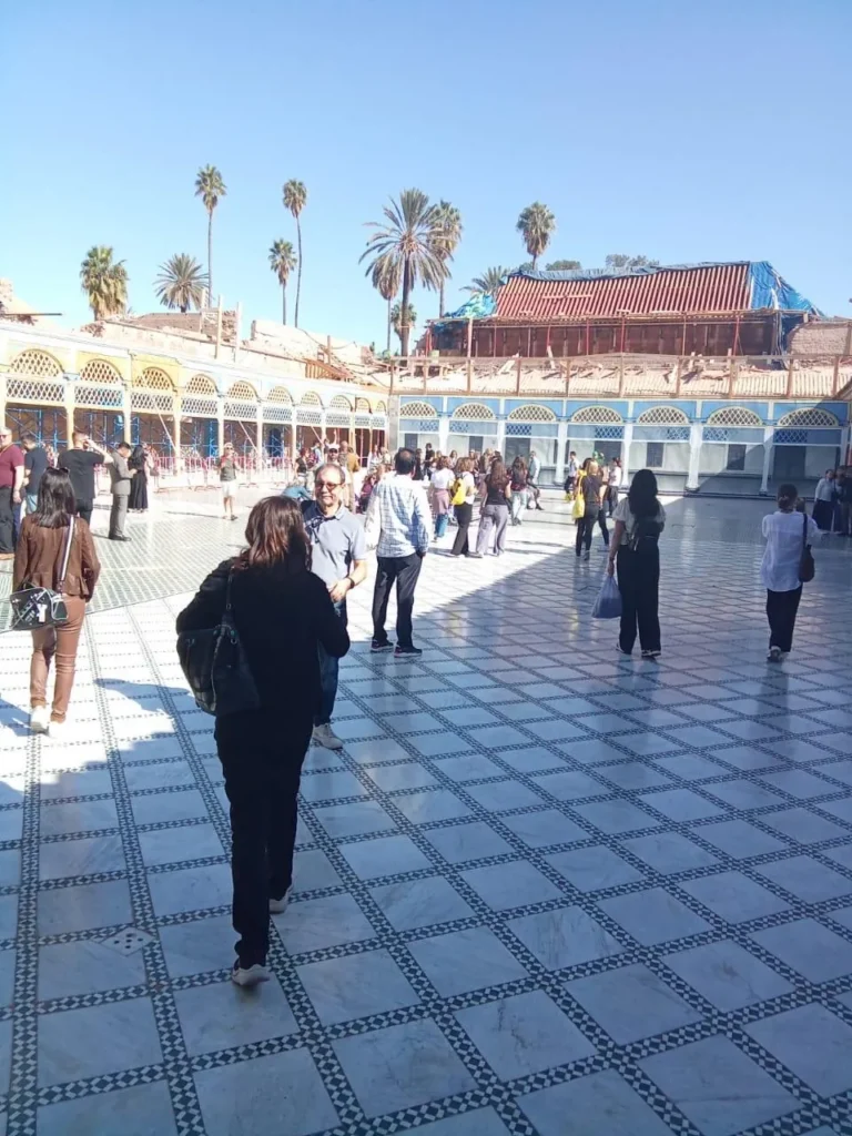 Visitors crossing the marble grand courtyard of Bahia Palace