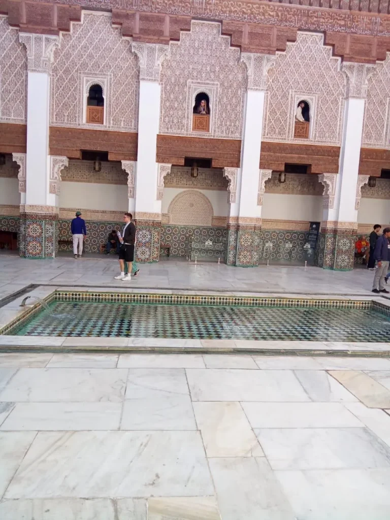 Courtyard pool and carved galleries of Ben Youssef Madrasa