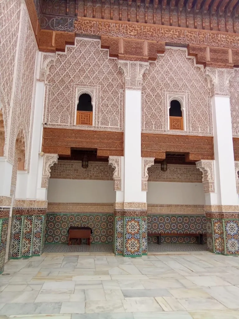 Carved cedar and stucco walls around the Ben Youssef Madrasa courtyard