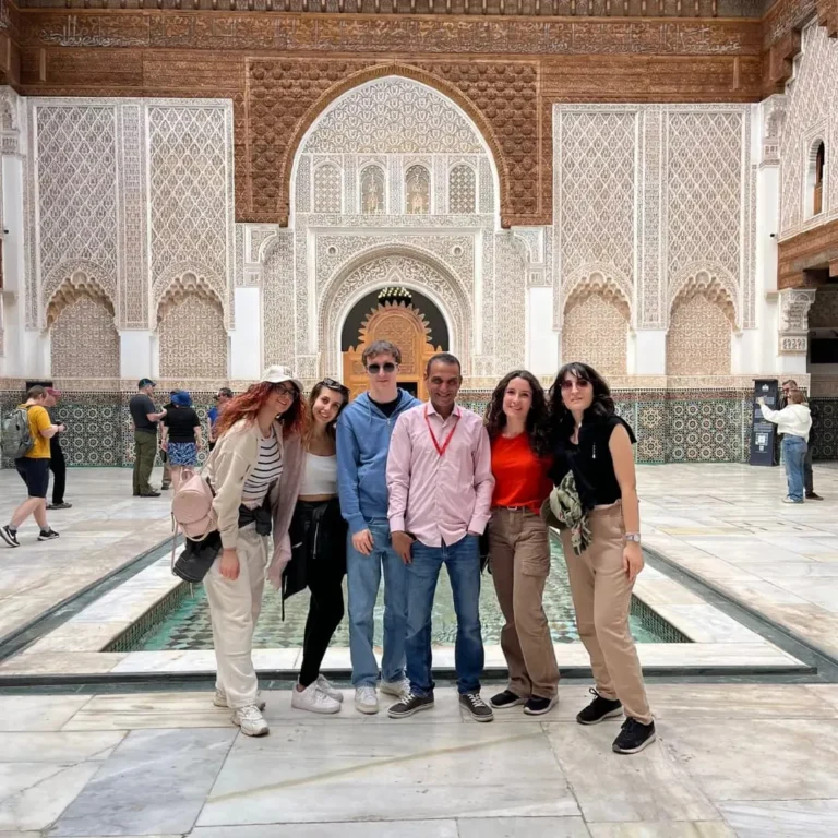 Small group beside the pool in the courtyard of Ben Youssef Madrasa