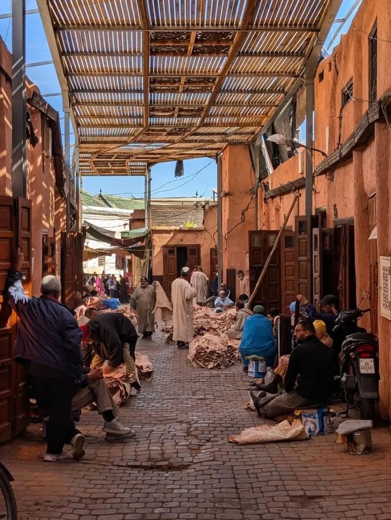 Covered souk passage with leather workers in Marrakech