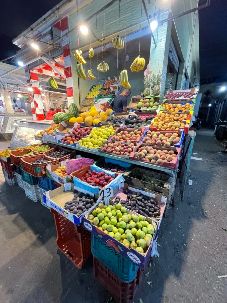 Fruit stall lit up at night in the Marrakech medina