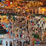 Crowds and lit food stalls on Jemaa el-Fna square at night
