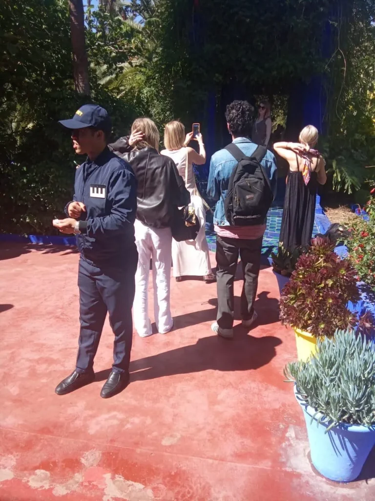 Visitors on a shaded path among the plants of the Majorelle Garden