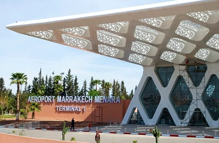 Terminal 1 entrance of Marrakech Menara Airport under its white lattice roof