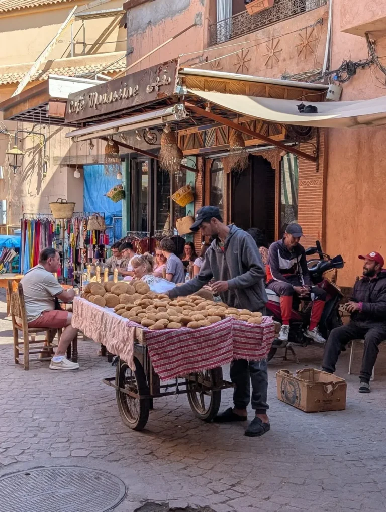 Food cart and diners on a small square in the medina