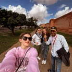Visitors and their guide along the red ramparts of the Marrakech medina