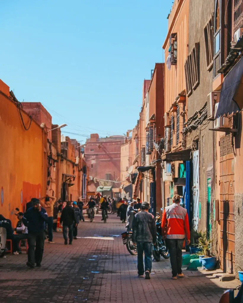 Busy medina street in Marrakech with shops on both sides