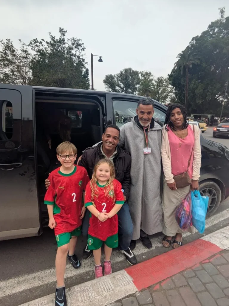 Family with their driver beside a private minivan in Marrakech