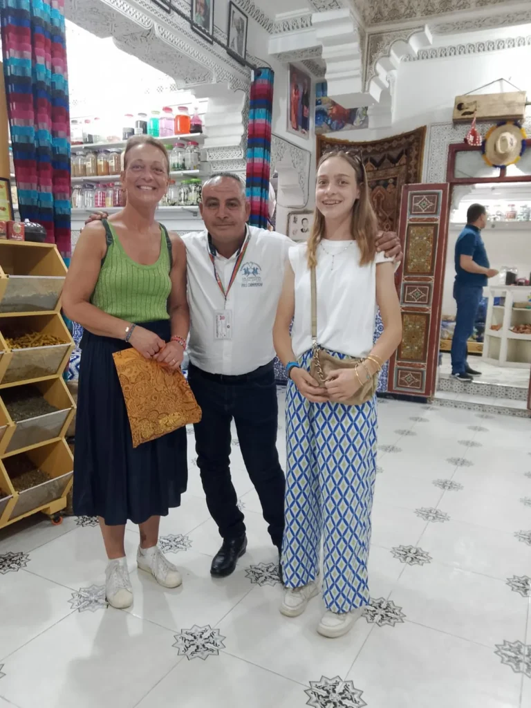 Two women and their guide inside a spice and herbal shop in the medina
