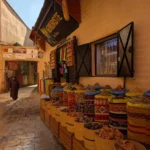 Baskets of spices outside a herbalist shop in a quiet medina lane
